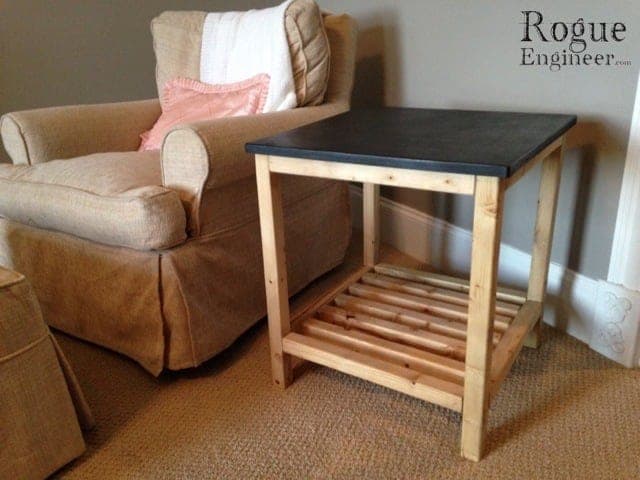 Small wooden side table with a slatted lower shelf and a three-board glued-up top