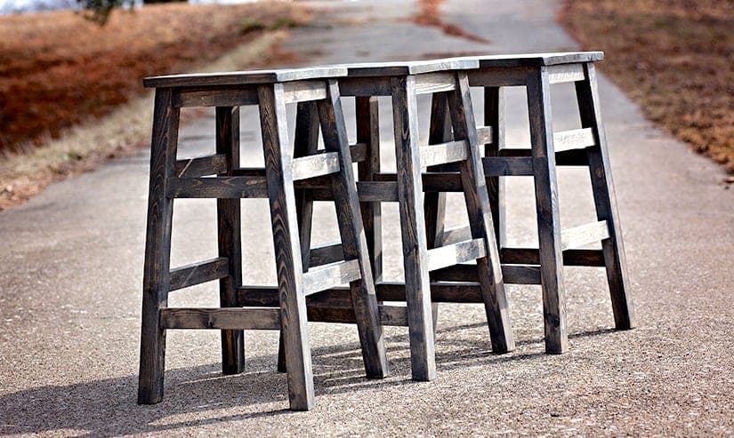 Small wooden stool with splayed legs and a square seat