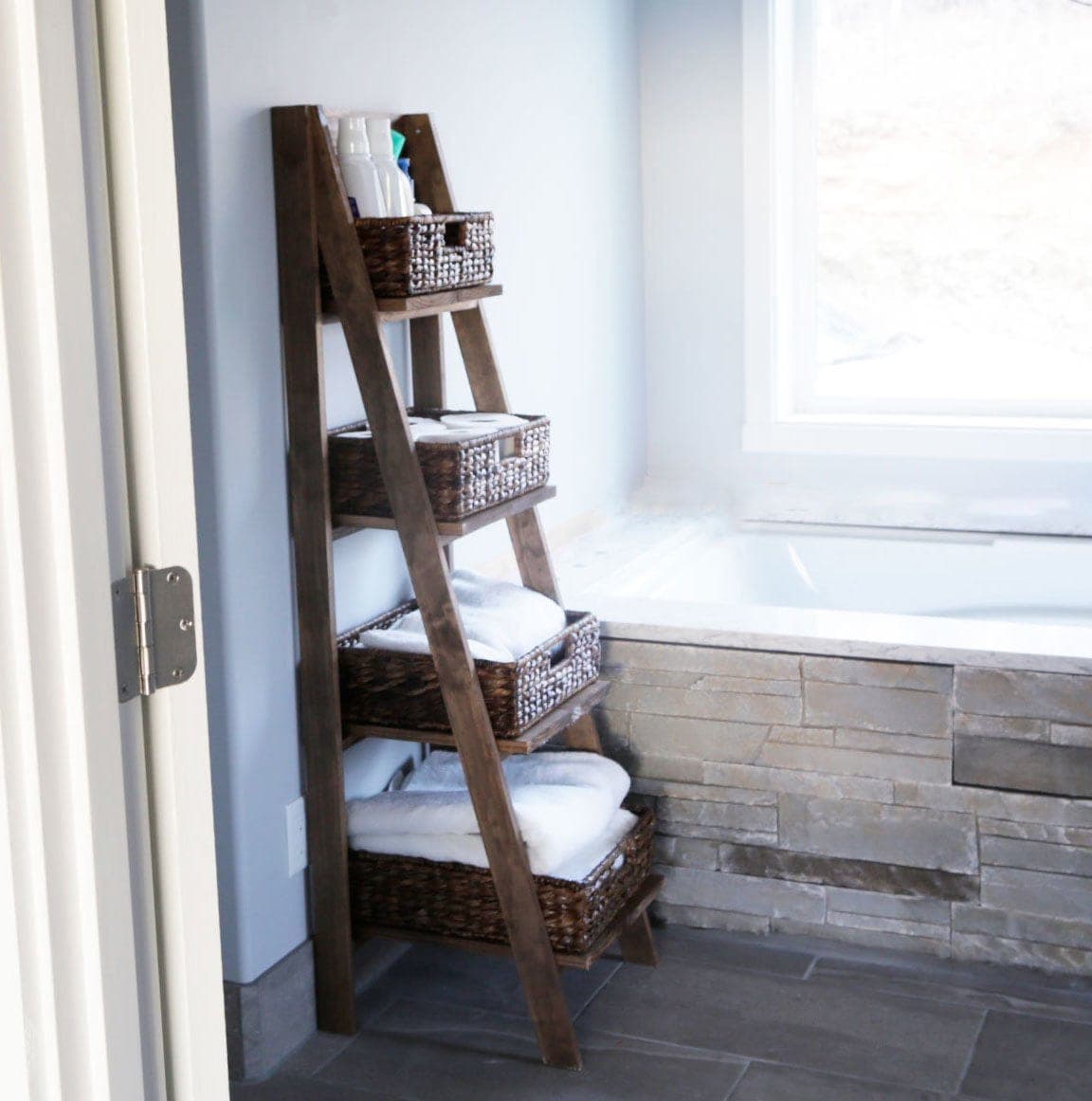 Freestanding wooden ladder shelf with angled front legs
