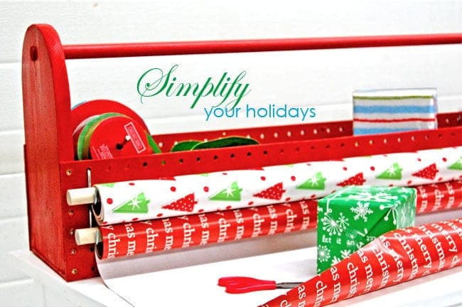 Toolbox-style caddy holding wrapping paper rolls with pegboard sides