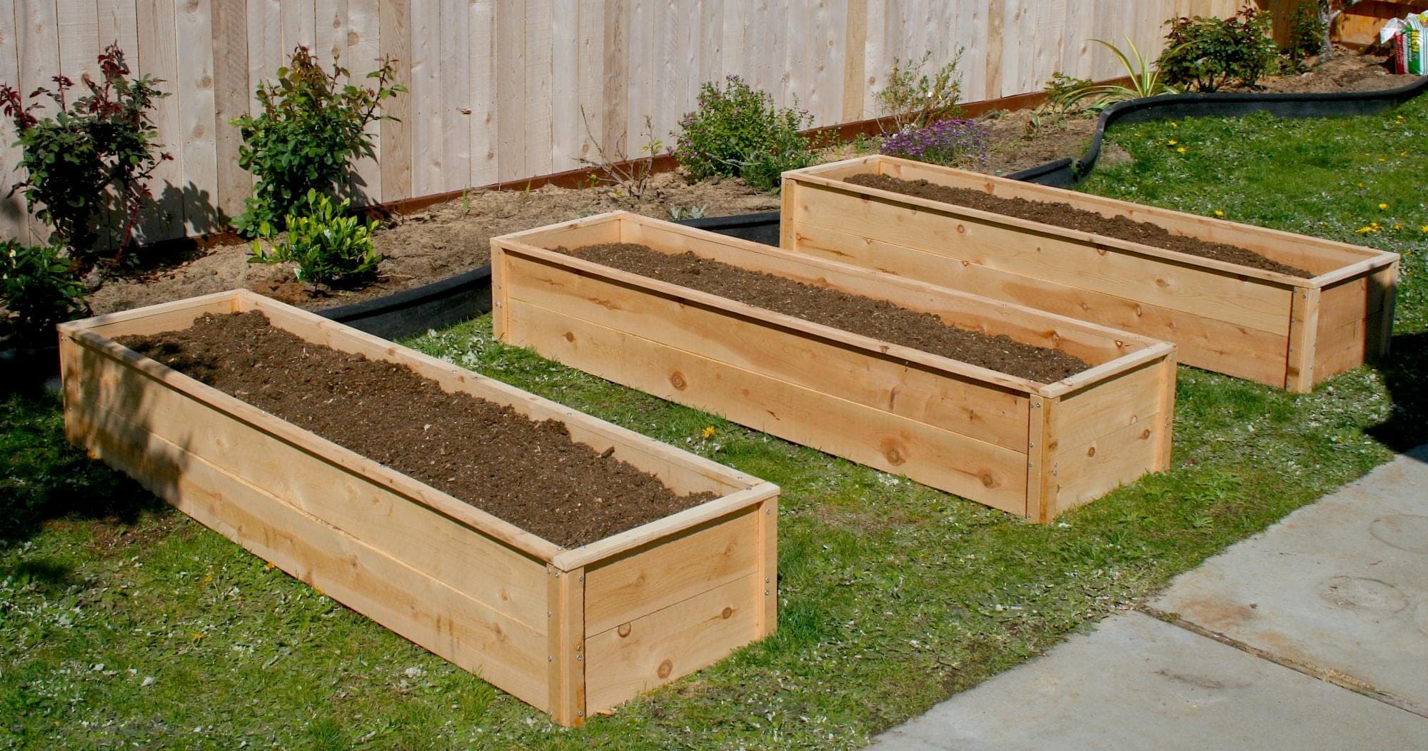 Long narrow cedar raised garden bed built from fence pickets