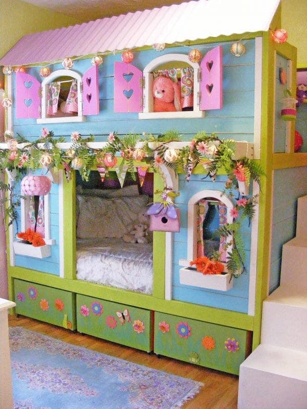 Playhouse-style bunk bed with arched windows and a rear storage shelf