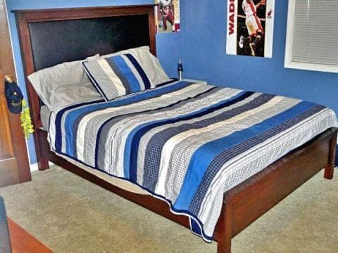 King-size headboard with a wood frame around a padded fabric panel