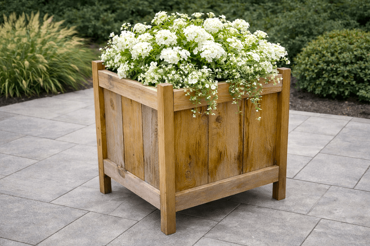Square cedar planter with picket panel sides raised on 2x2 legs