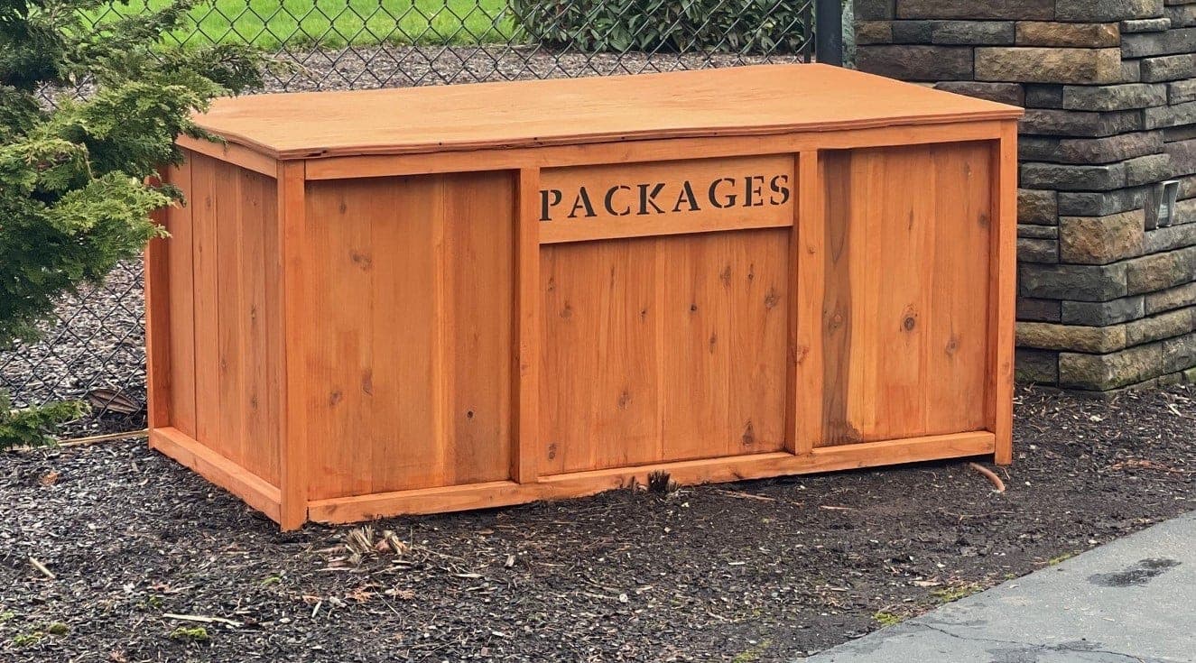 Outdoor package delivery drop box with cedar-skinned panels and a hinged lid