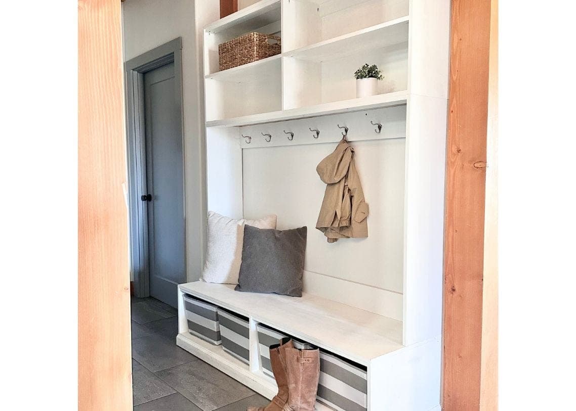 Wall-mounted frameless mudroom hutch with coat hooks and an upper shelf