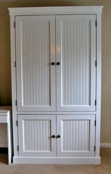 Tall two-door nursery armoire with framed doors and moulding