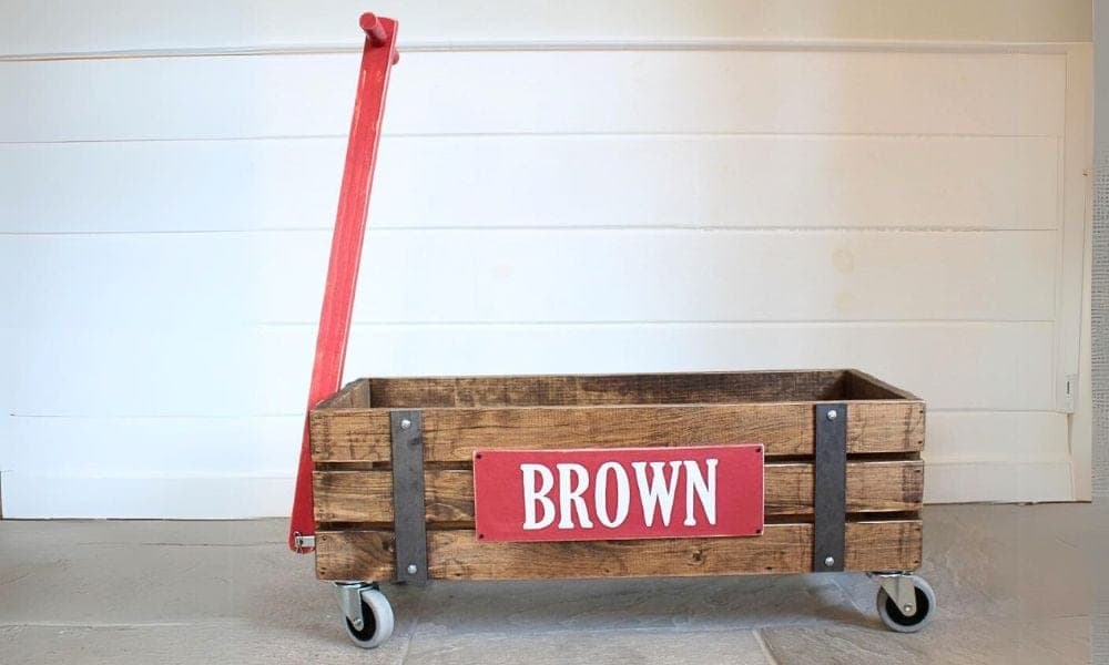 Vintage-style wooden pull wagon with metal decorative side strips