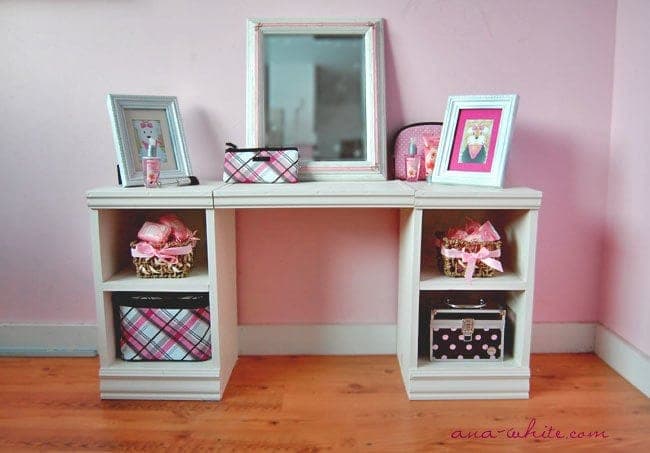 Child's play vanity with two small cabinets, a bench seat, and a mirror