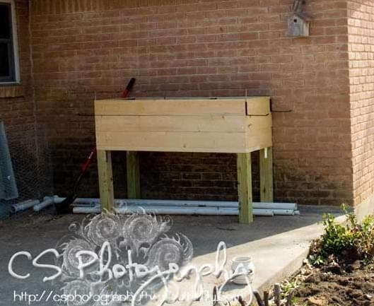 Elevated wooden planter box on four legs