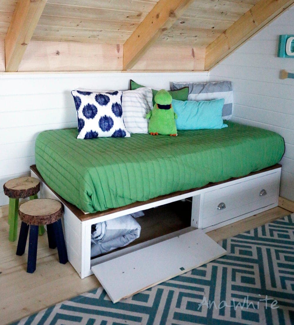 Low platform bed with a hinged flip-down storage panel on the side