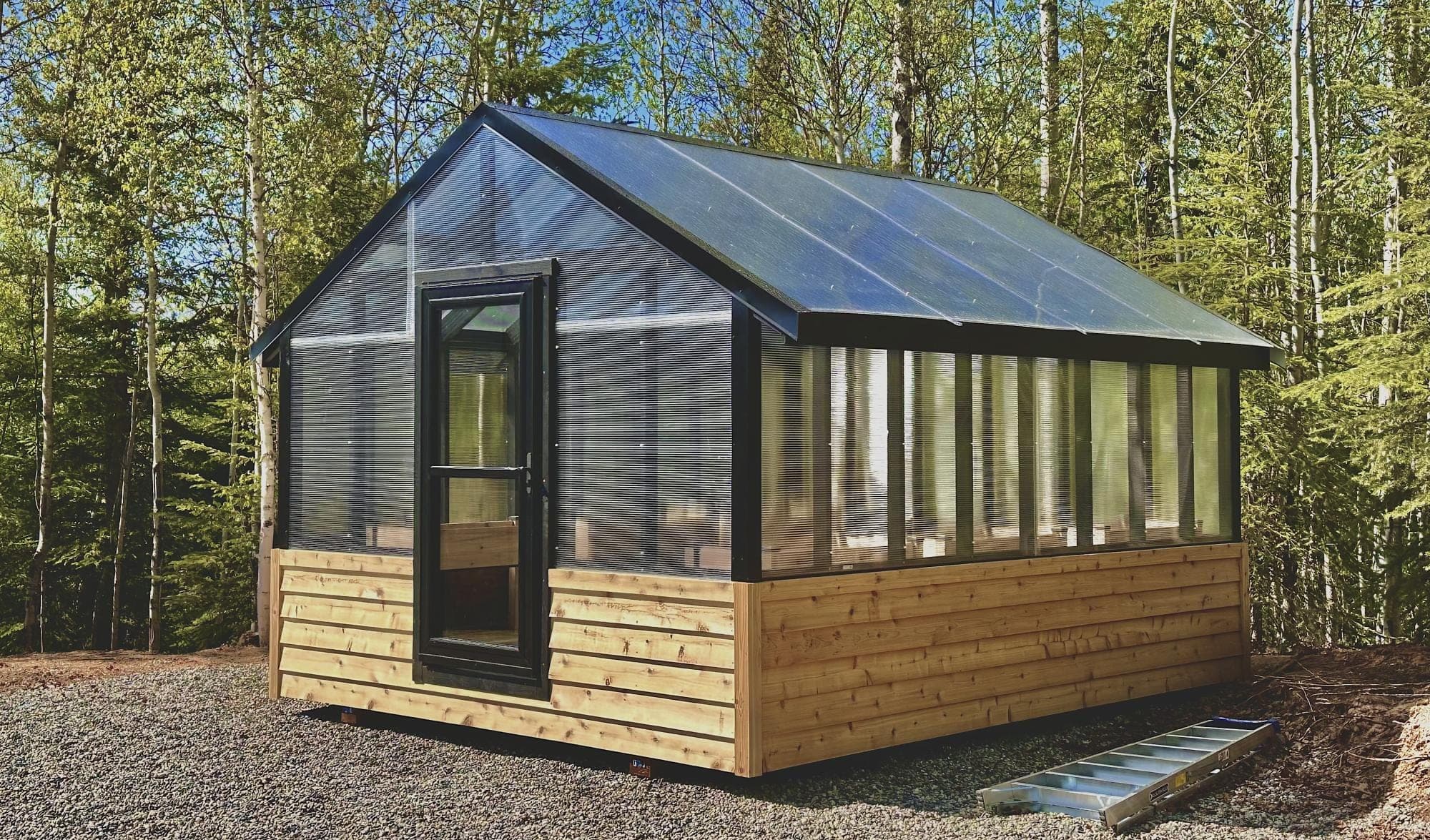 Stick-framed 12x16 greenhouse with translucent twinwall polycarbonate walls and roof