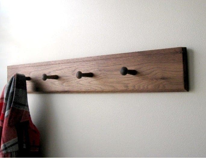 Shaker peg rail with turned pegs mounted on a wall