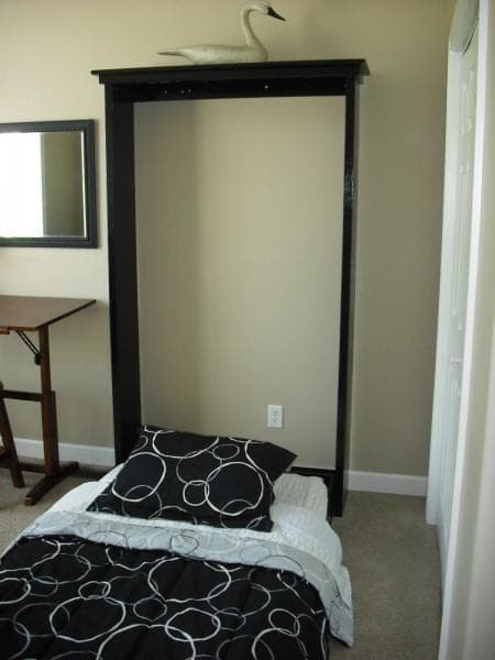 Wall-mounted murphy bed with hinged mattress panel