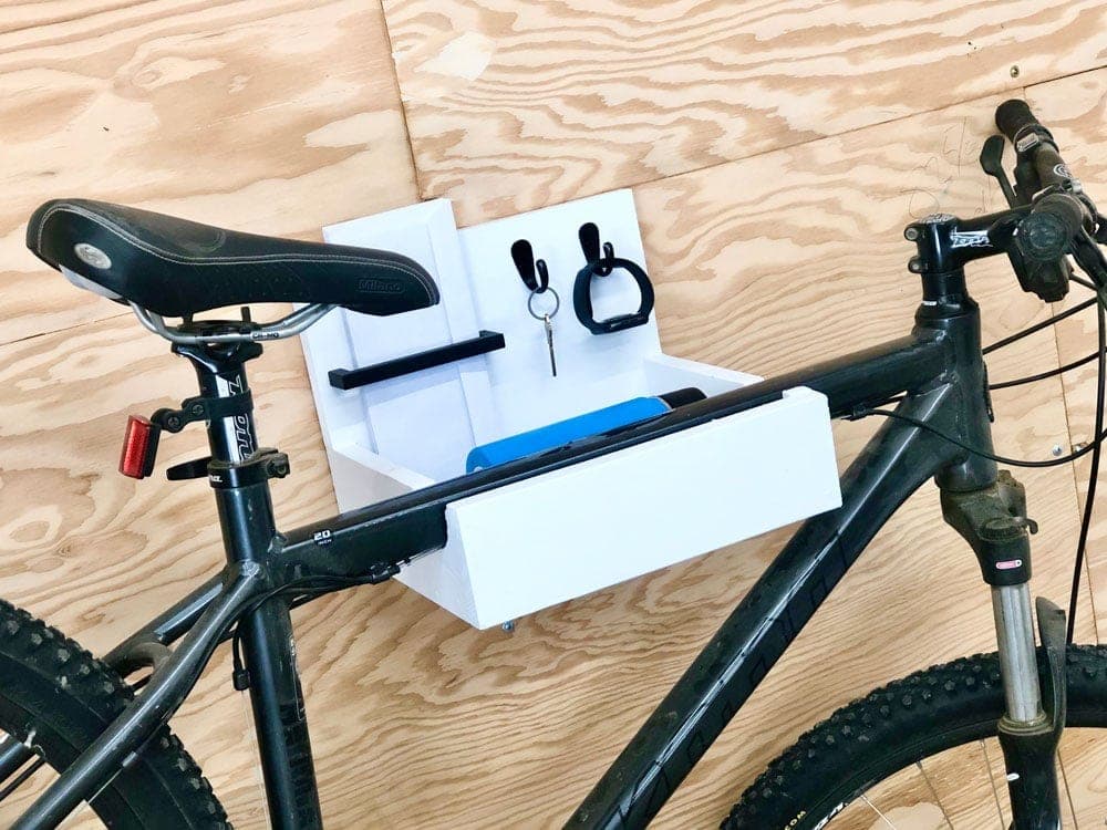 Wall-mounted wooden bike hanger with a shelf and hooks