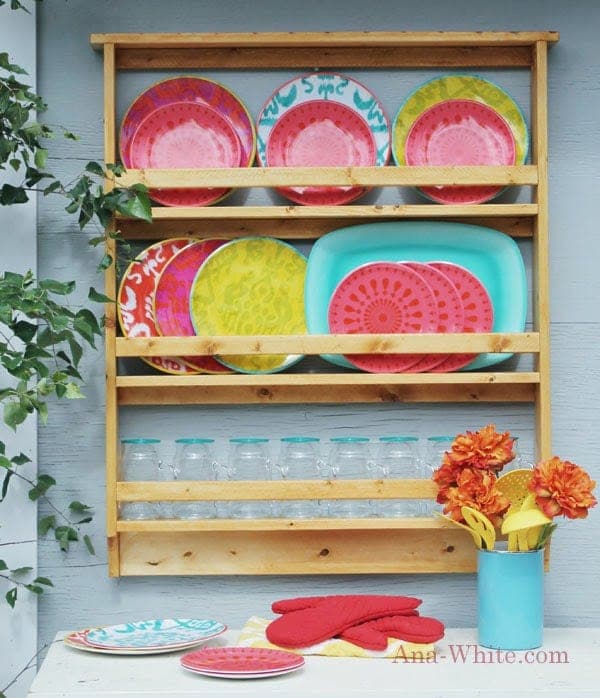Outdoor wooden plate rack with open shelves for a patio kitchen