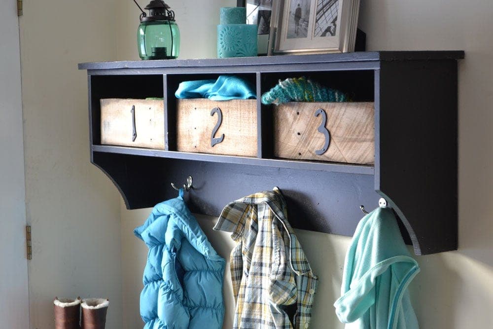 An entryway set with a cubby bench below and a hook-and-shelf coat organizer above