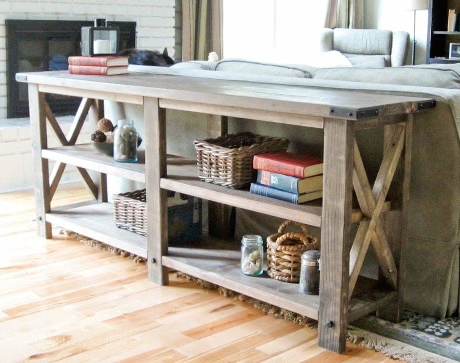Farmhouse console table with X-brace ends, planked top, and decorative bolt hardware