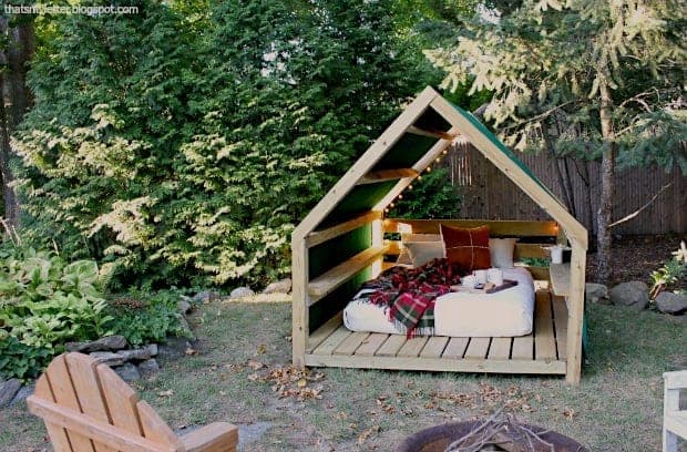 Outdoor gable-roofed cabana lounge structure on a raised deck