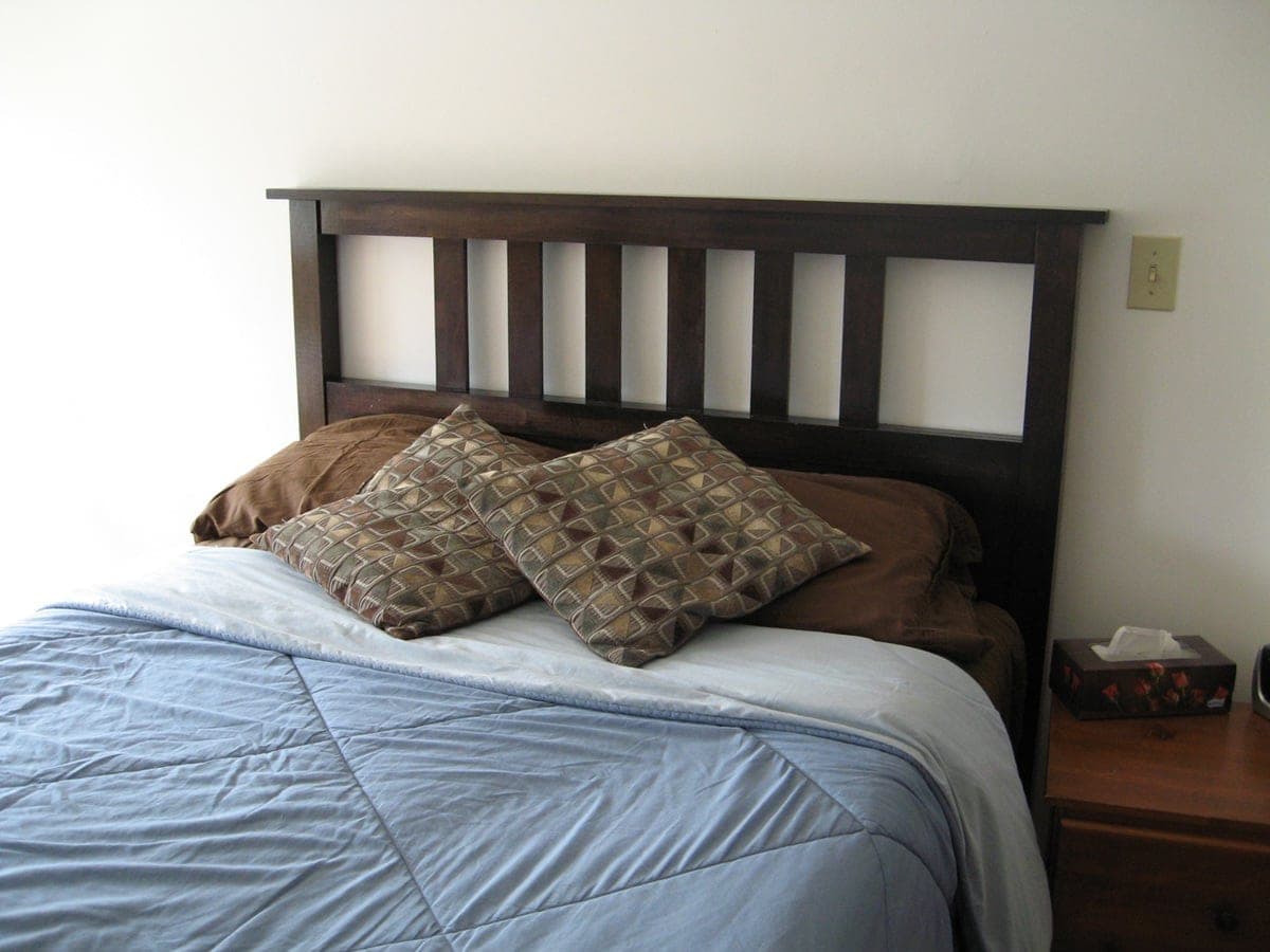 Full-size slatted headboard with laminated posts and a thin paneled center