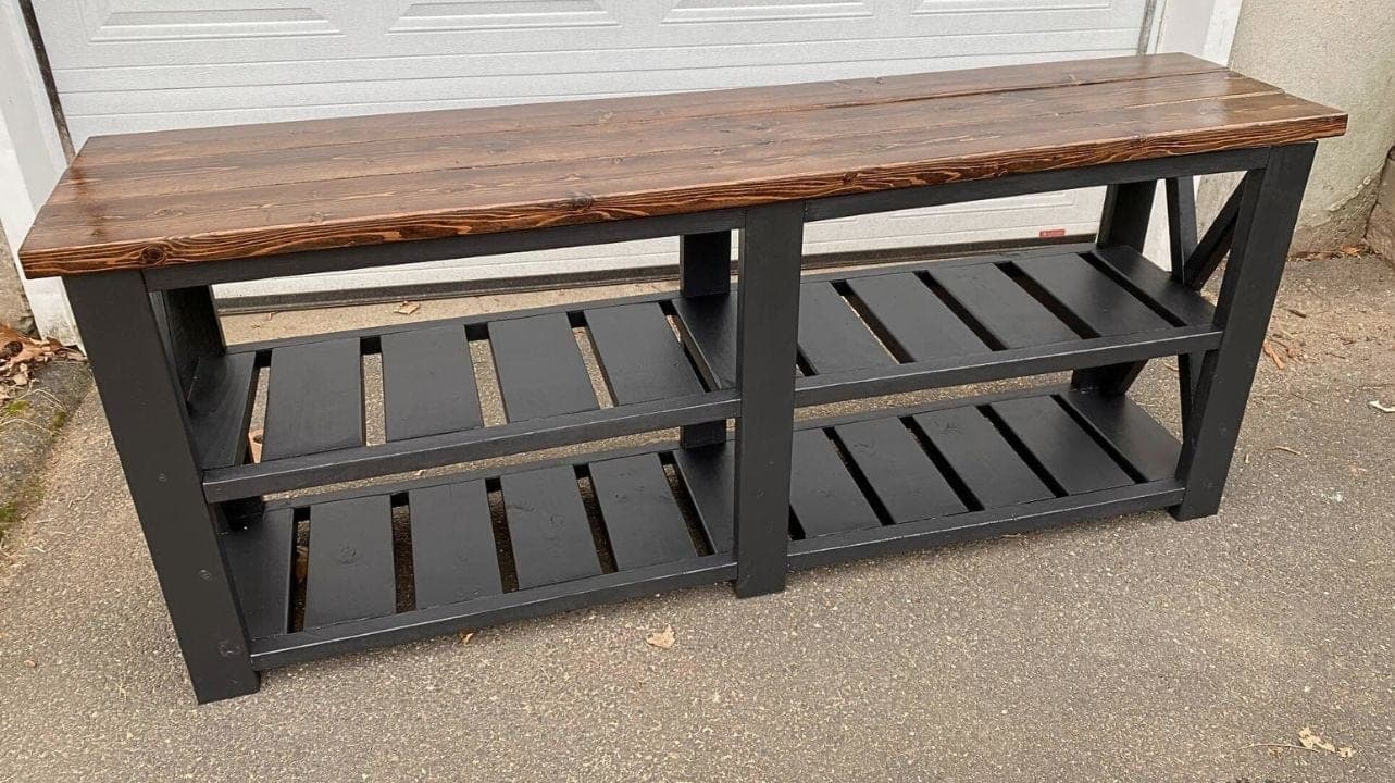 Farmhouse-style console table with X-braced trestle legs and a slatted lower shelf