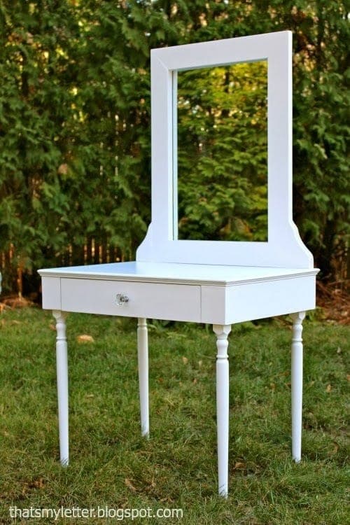 Kid-sized play vanity with turned stair-baluster legs, a slide-out drawer, and a mirror
