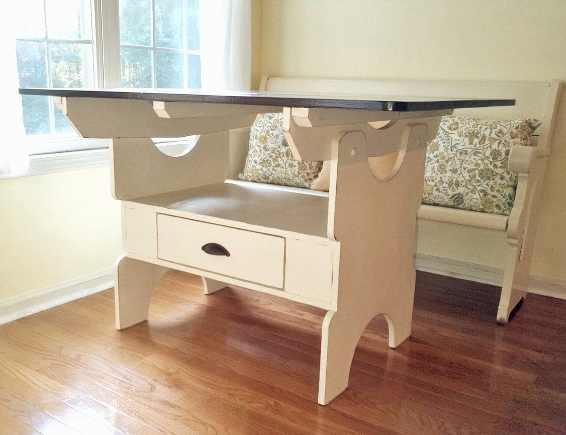 Dining table with a storage box base and a drawer