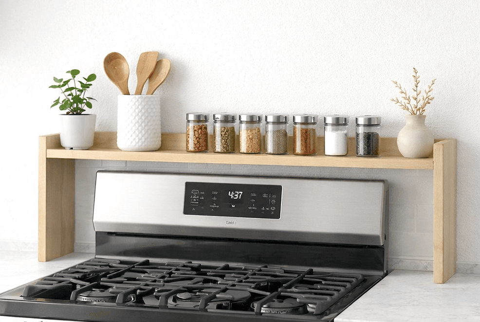 Small wooden shelf fitted into the open alcove above a stove