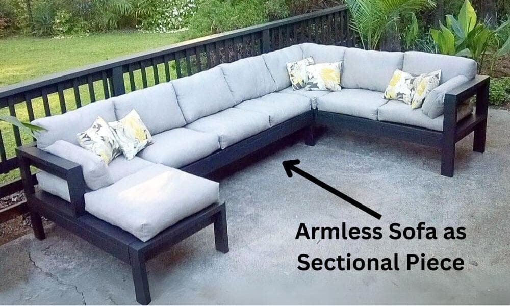 Armless outdoor sectional frame piece with cushions between two sofa sections