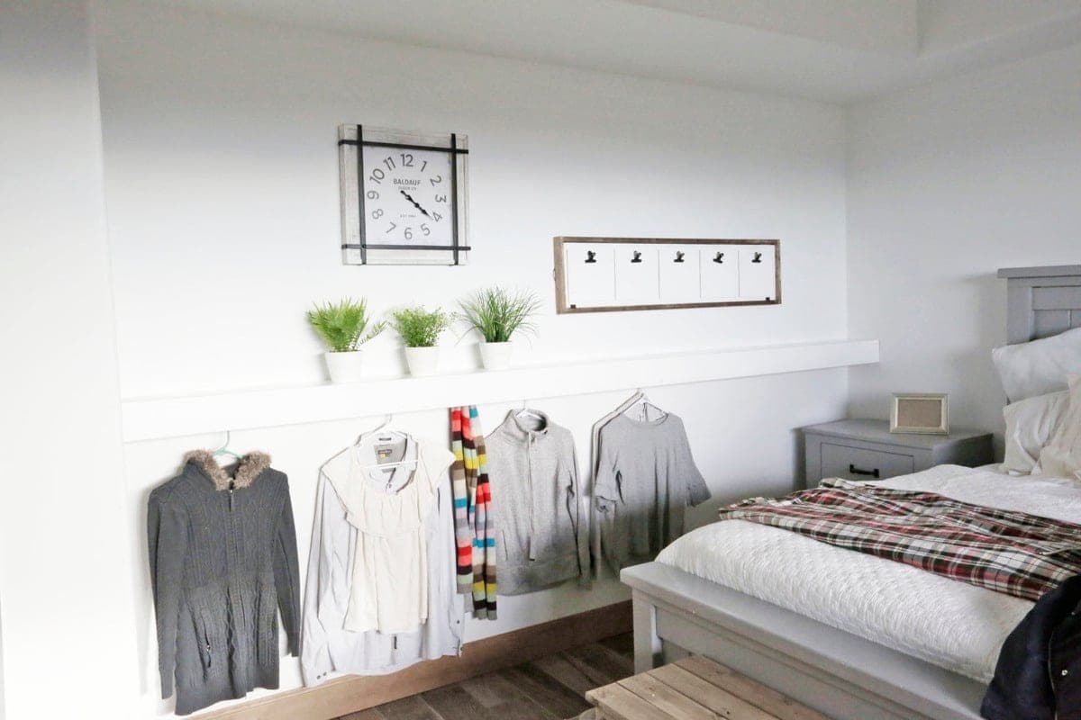 Floating wood shelf with hidden hanging pegs underneath
