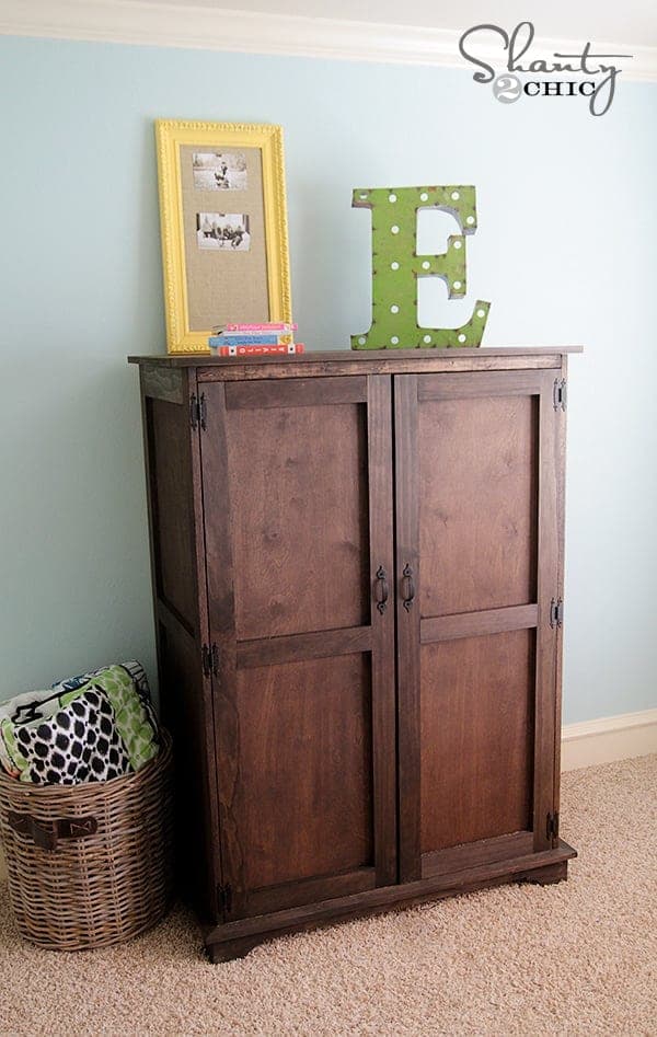 Plywood armoire cabinet with a scrolled footer and full doors