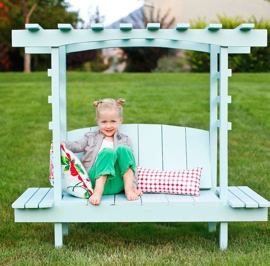 Kid-sized cedar garden bench with a trellis arbor and built-in flower pot shelves