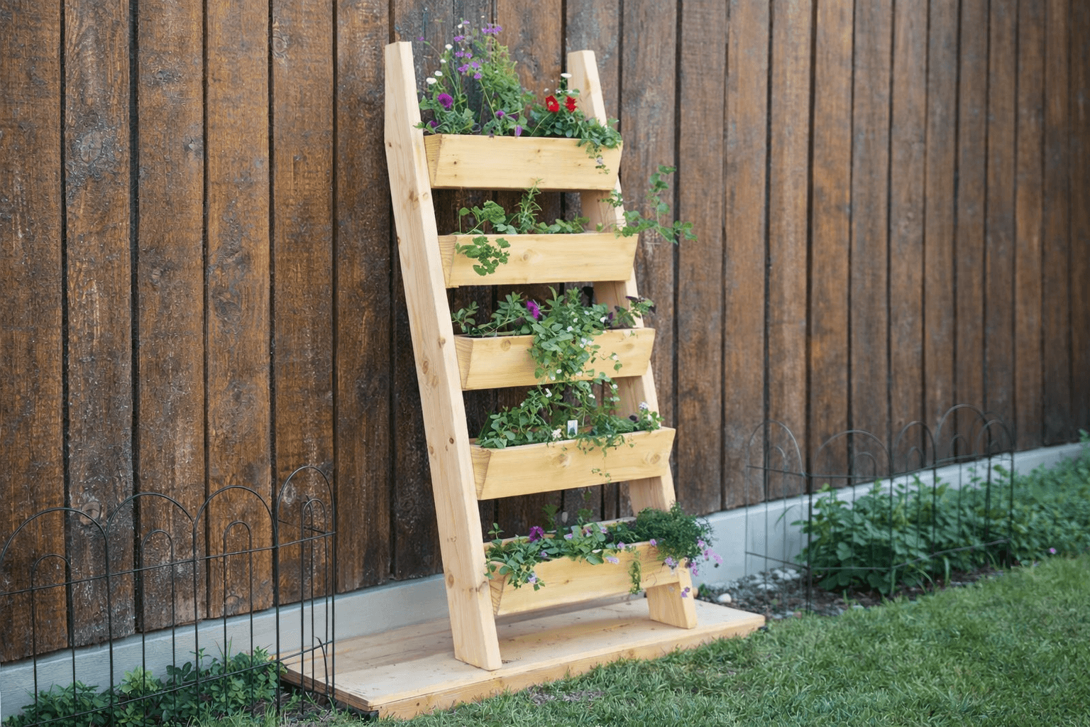Tiered cedar ladder planter with five staggered boxes leaning against a wall