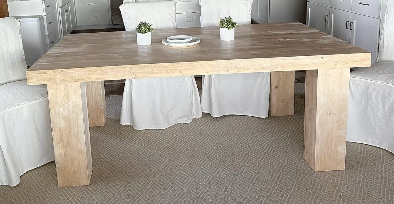 Minimalist modern dining table with a plank top