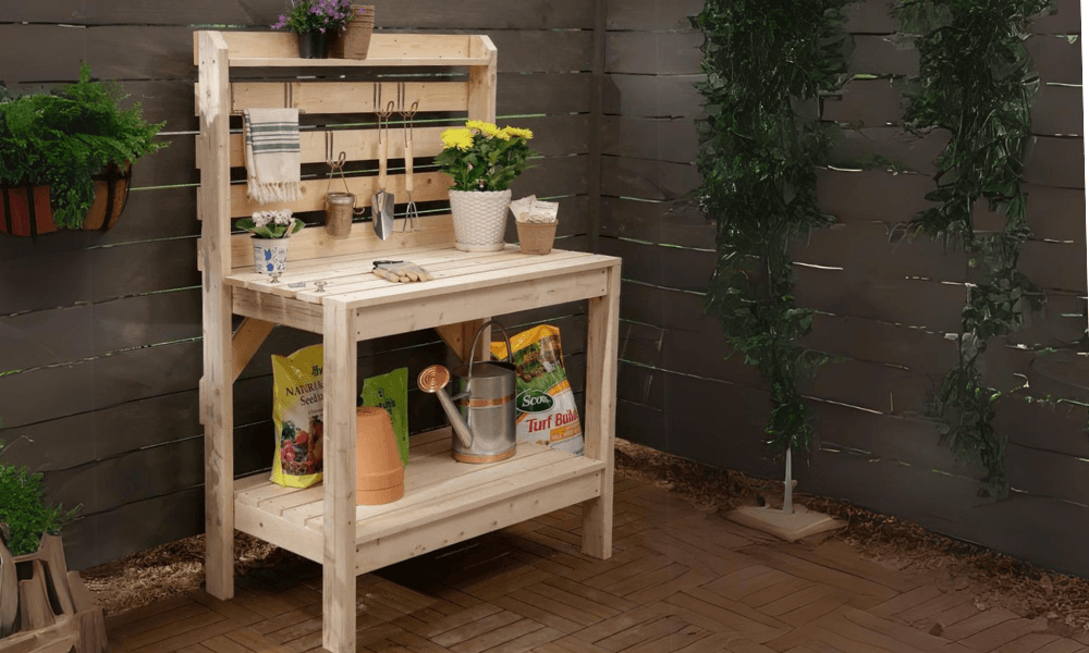 Wooden potting bench with slatted work surface, bottom shelf, slatted back, and top hutch shelf