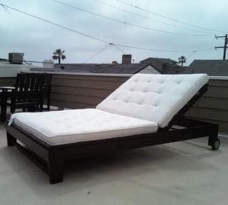 Outdoor chaise lounge with a hinged, reclining back