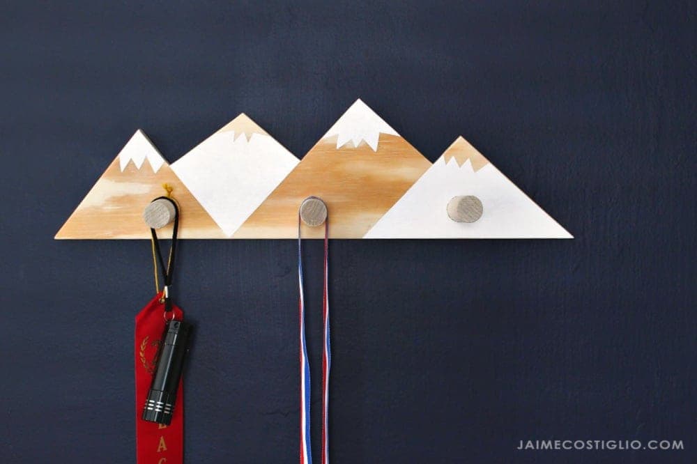 Mountain-shaped plywood wall rack with dowel peg hooks