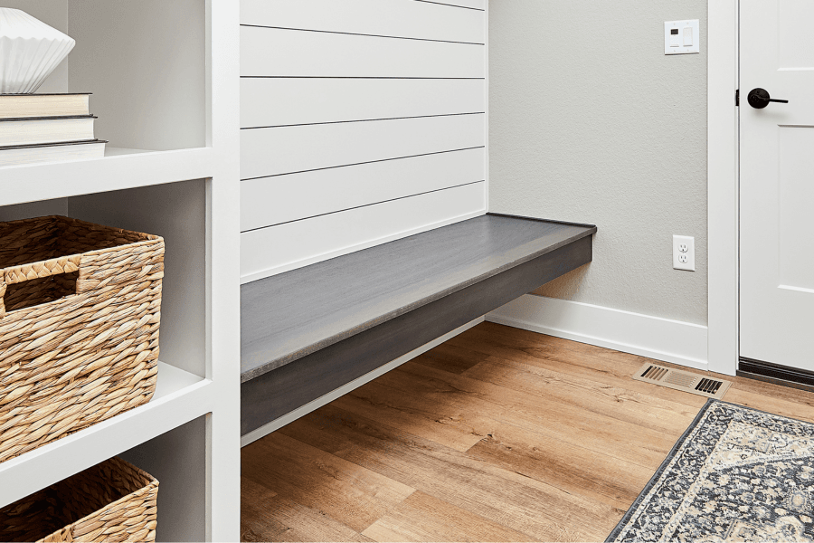 A wall-mounted bench with no visible legs, built into a wall nook
