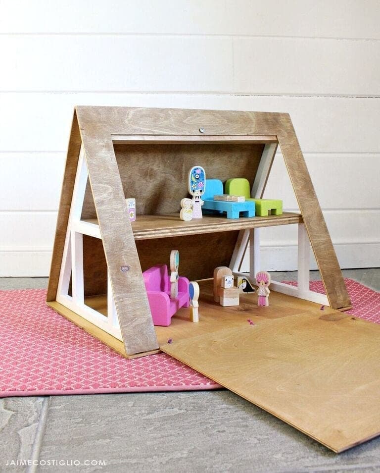 A-frame plywood dollhouse with a hinged roof side that opens for play