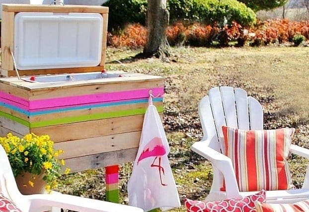 Outdoor cooler stand clad in reclaimed pallet boards with a hinged wood-framed lid