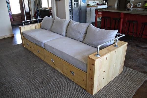 Modern wood sofa with hidden storage drawers and a black pipe back rail