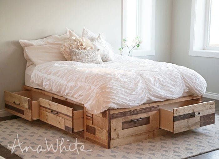 Queen platform storage bed with six drawers clad in reclaimed scrap wood