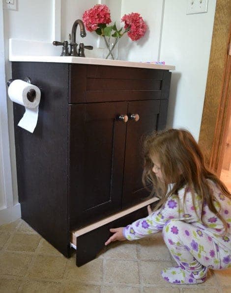 Pull-out step stool drawer built into the toekick of a bathroom vanity