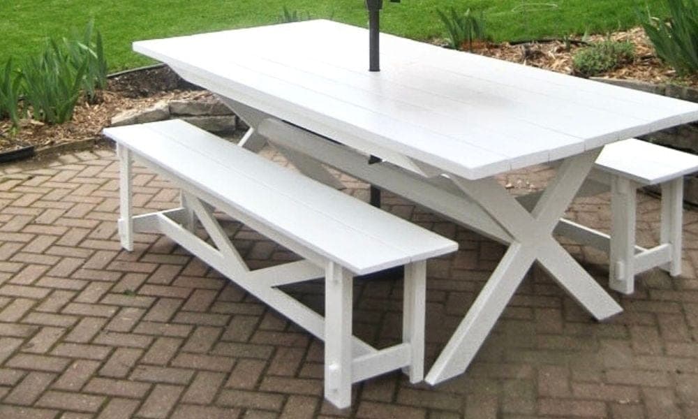 Outdoor dining table with a crossing X-shaped base