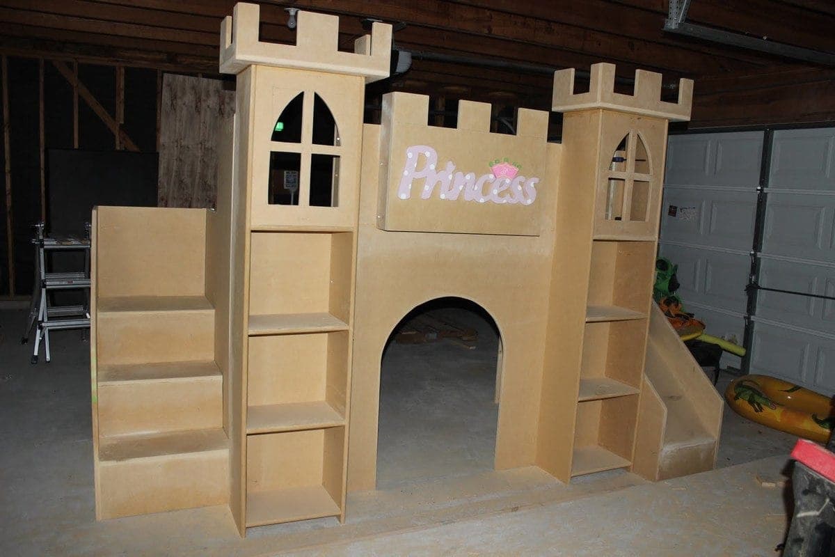 Castle-themed loft bed with a slide and stairs