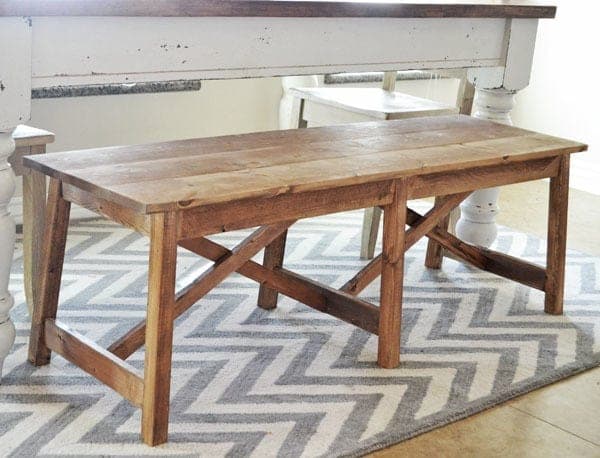 Rustic wood bench with double-X braced, slightly splayed legs