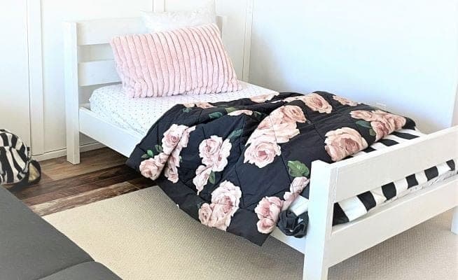 Simple twin bed frame with a taller three-rail headboard and low footboard