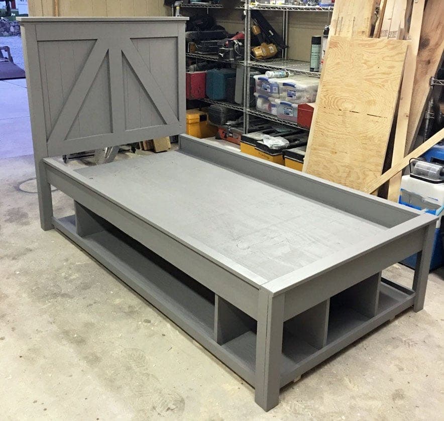 Twin platform bed with open storage cubbies built into the base