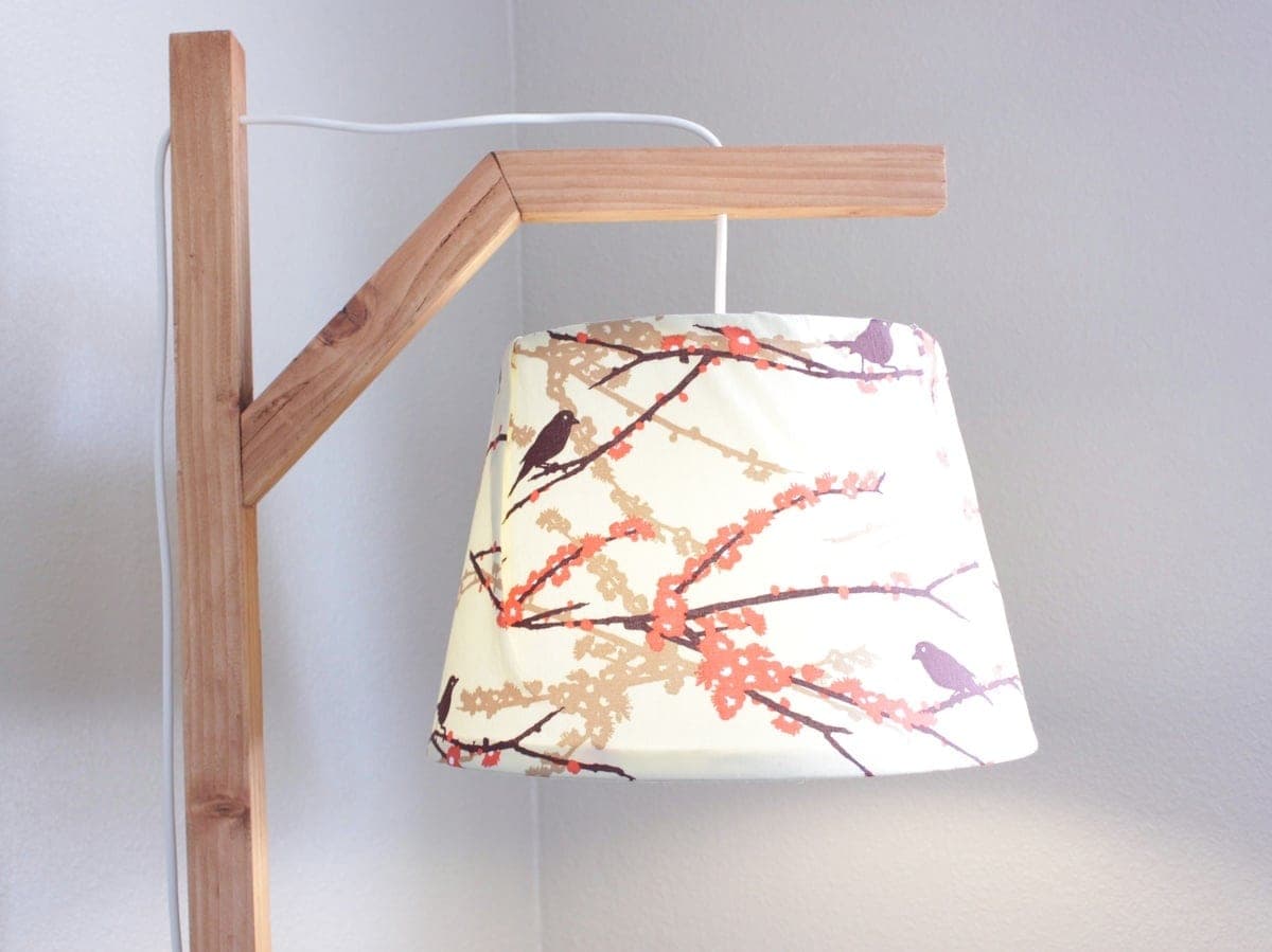 Slim modern wooden floor lamp with an angled arm