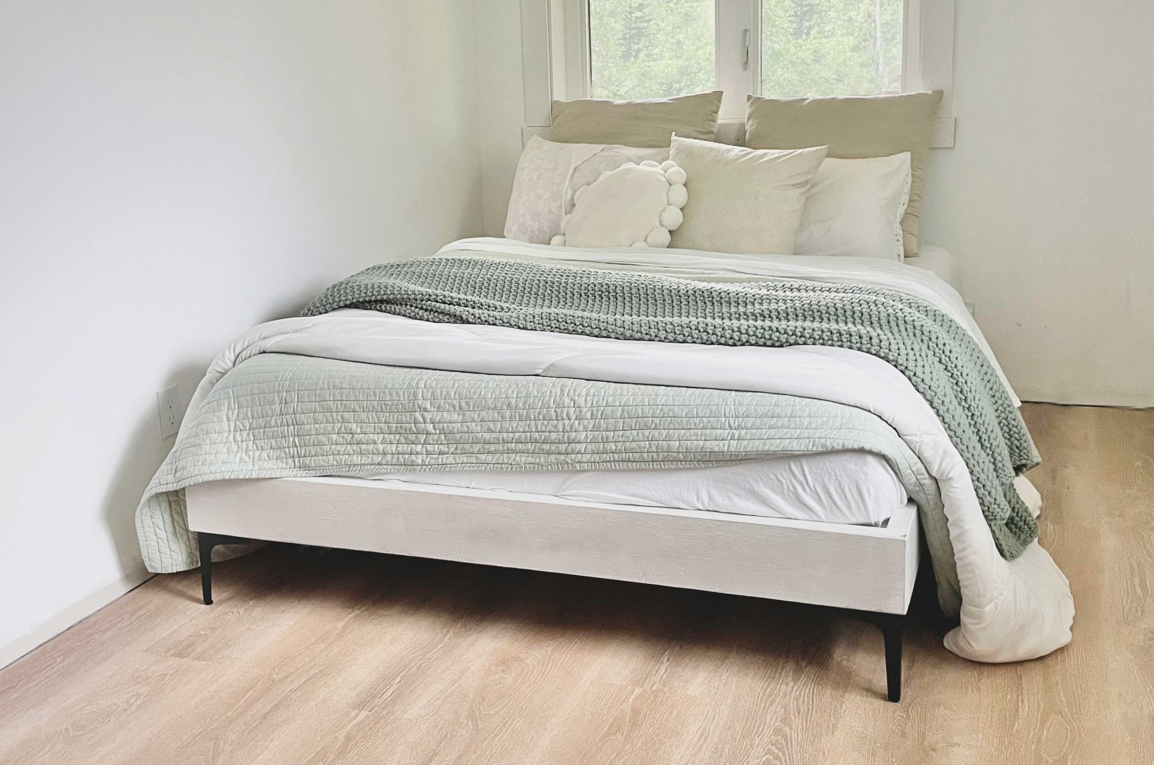 A minimal 2x6 box bed frame with slats and legs, no headboard or footboard